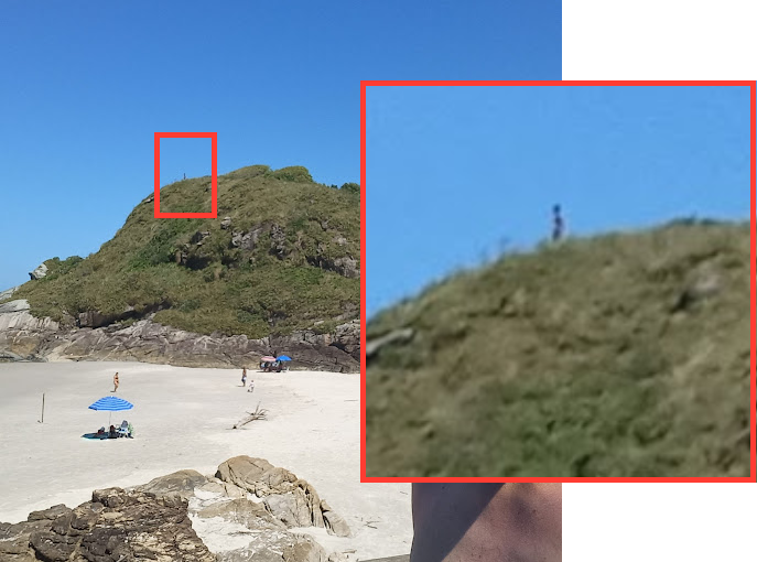 Imagem mostra homem em cima do morro; do lado direito, há um recorte com zoom da cena