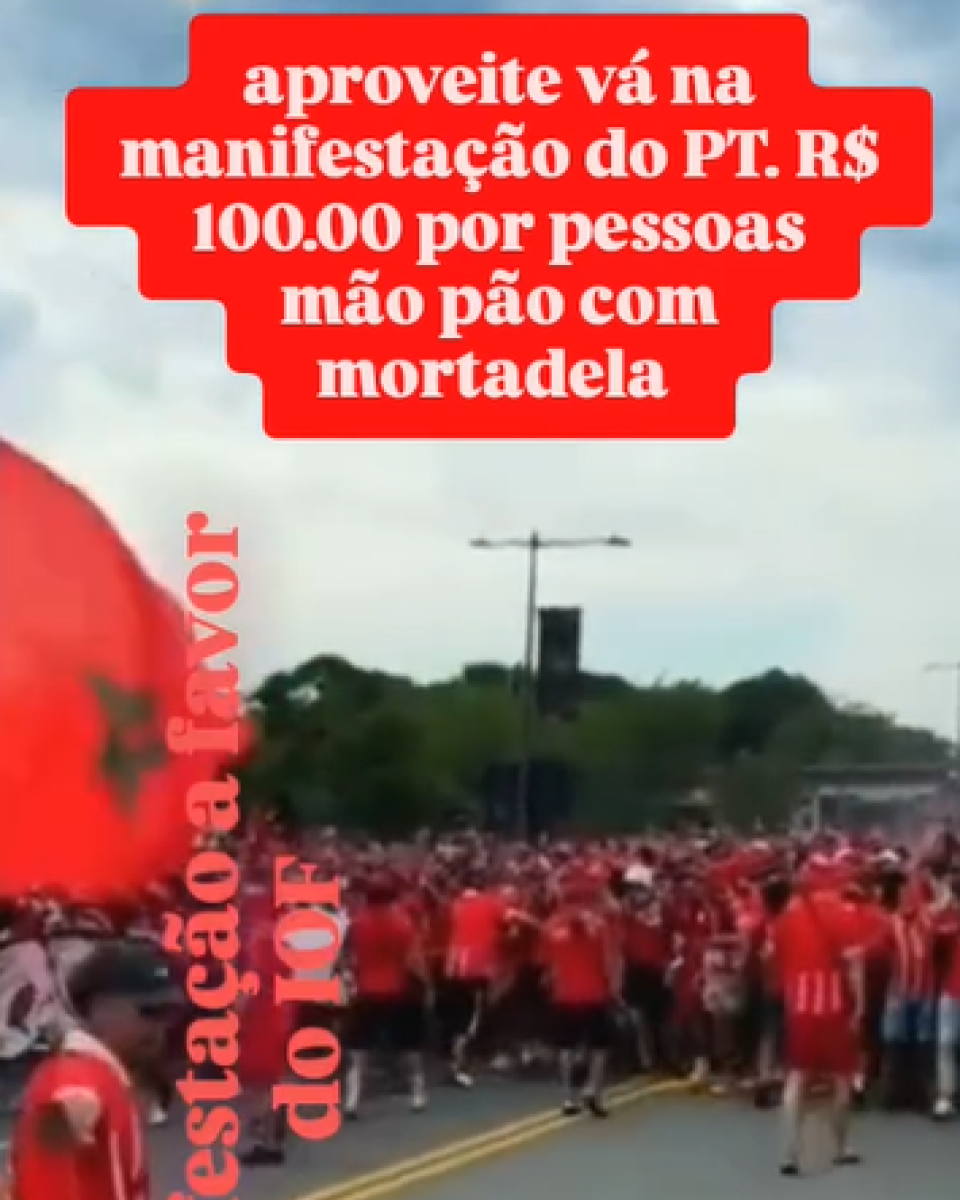 Frame de vídeo compartilhado nas redes mostra uma multidão usando roupas vermelhas caminhando por uma avenida. Em primeiro plano, há duas legendas, uma na horizontal e outra na vertical. Na horizontal, é possível ler: ‘Aproveite, vá na manifestação do PT. R$ 100 por pessoa. Pão com mortadela’. Já na vertical, aparece escrito: ‘Manifestação a favor do IOF’.