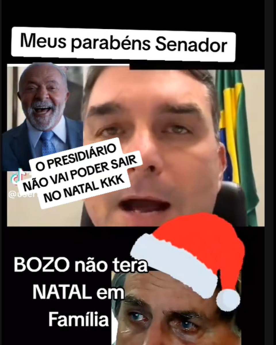 A imagem é dividida em duas partes. Na parte superior, aparece o senador Flávio Bolsonaro — homem de pele clara, cabelo curto e escuro, enquadrado de frente, com uma bandeira ao fundo. Ao lado dele há a foto do presidente Lula, homem de pele clara, cabelo curto e barba grisalha, vestindo terno escuro e gravata clara. Na parte inferior, há a foto de Jair Bolsonaro, de pele clara, cabelo curto e escuro, usando um gorro vermelho de Natal desenhado digitalmente, com lágrimas visíveis no rosto. Sobrepostos às imagens, há diferentes textos em letras brancas.