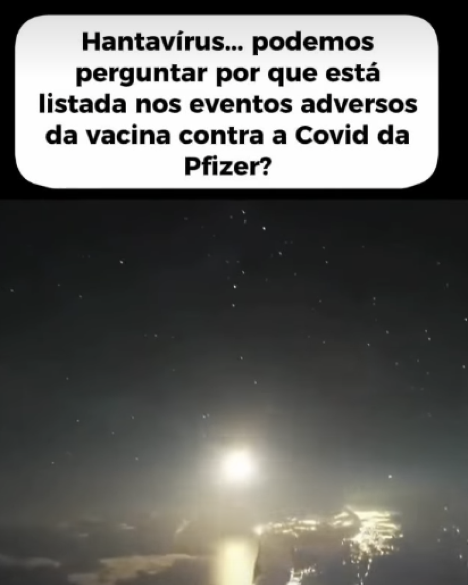 Imagem mostra uma cena escura ao ar livre durante a noite. O céu está cheio de pequenos pontos brilhantes semelhantes a estrelas. Na região central inferior da imagem há uma luz intensa refletida sobre uma superfície que parece água ou solo molhado. Ao redor, a paisagem aparece escura e pouco definida. Na parte superior da imagem há uma caixa branca com cantos arredondados contendo um texto em letras pretas que diz: ‘Hantavírus... podemos perguntar por que está listada nos eventos adversos da vacina contra a Covid da Pfizer?’. 