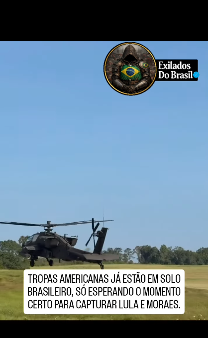 a imagem mostra o print de um vídeo em que aparece um helicóptero militar em um campo aberto. Um texto sobreposto com uma tarja branca afirma que 'tropas americanas estão no Brasil, apenas esperando o momento certo para capturar Lula e Alexandre de Moraes'