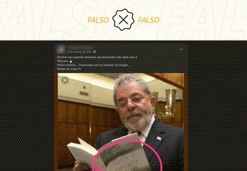 É montagem foto do ex-presidente Lula lendo um livro de cabeça para baixo